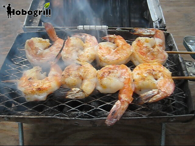 portable bbq grill cooking buttery garlic shrimp kabobs